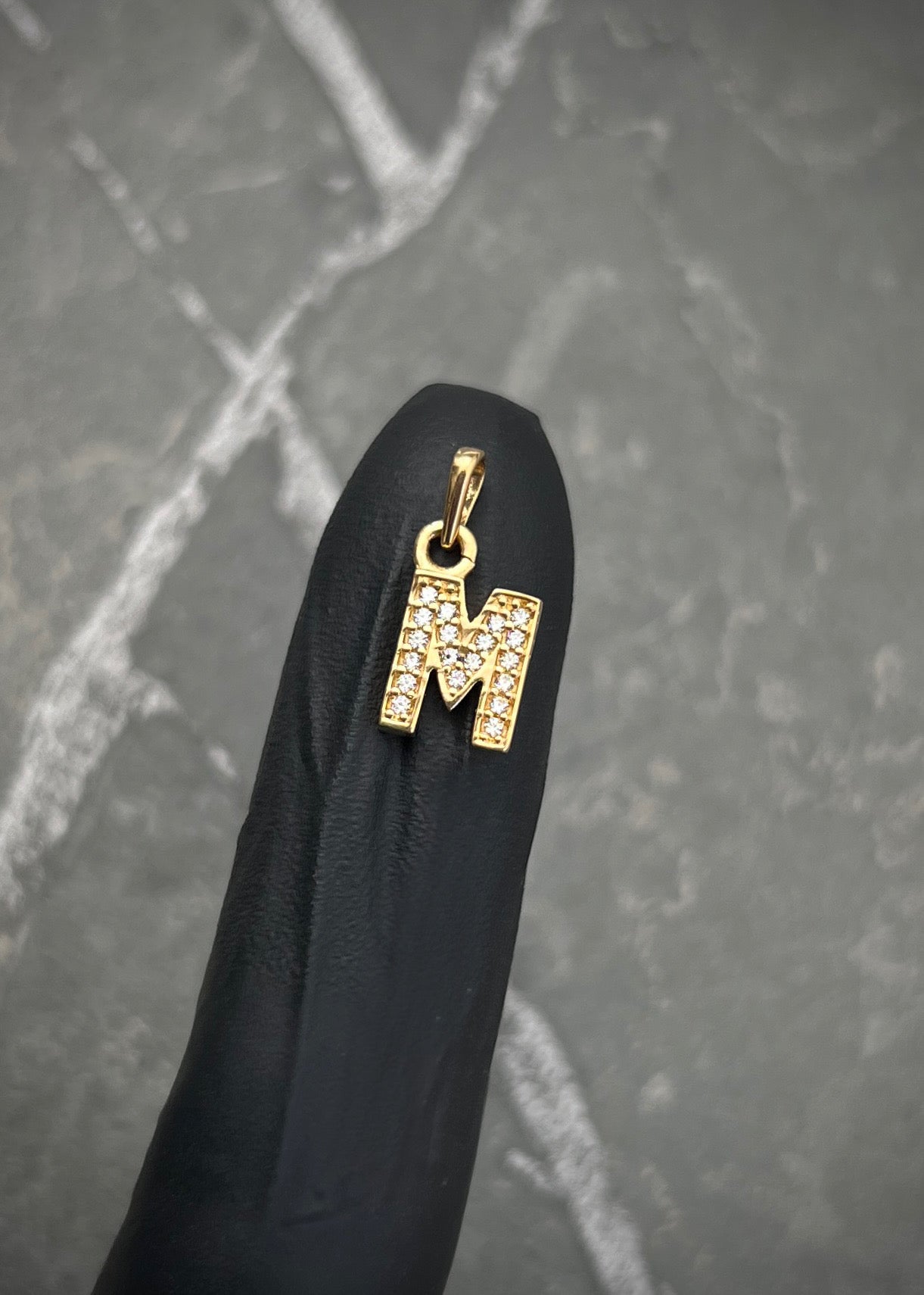 Dije letra M con swarovski blanco 0.9gr / Largo 1.5cm / Oro Amarillo Nac B