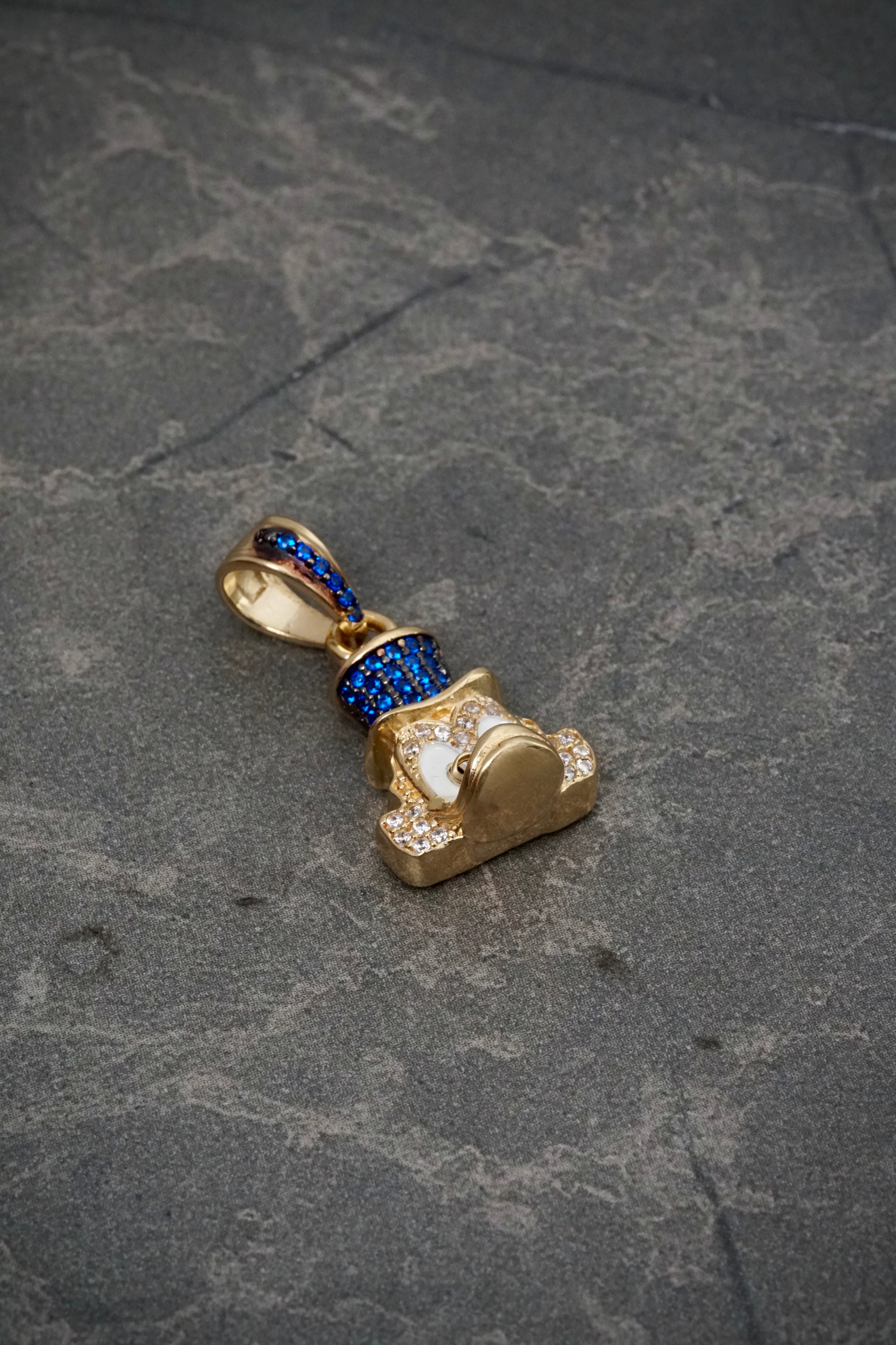 Dije tio rico con swarovski azul y blanco 5.05gr / Largo 2.5cm / Oro Amarillo Nac P