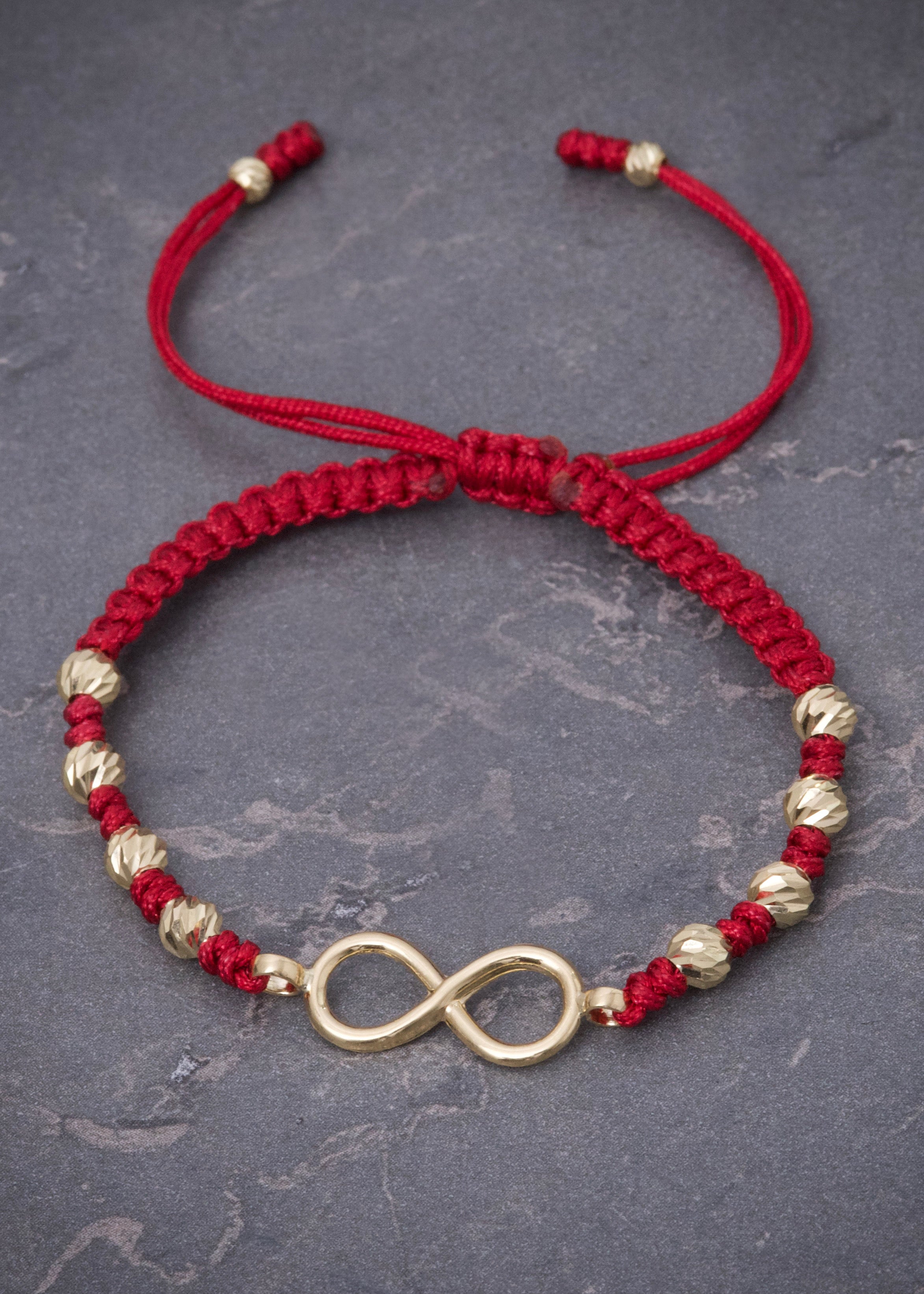 Pulsera en hilo rojo con herraje infinito y bolas diamantadas 1.1gr / Oro Amarillo (Joya) M