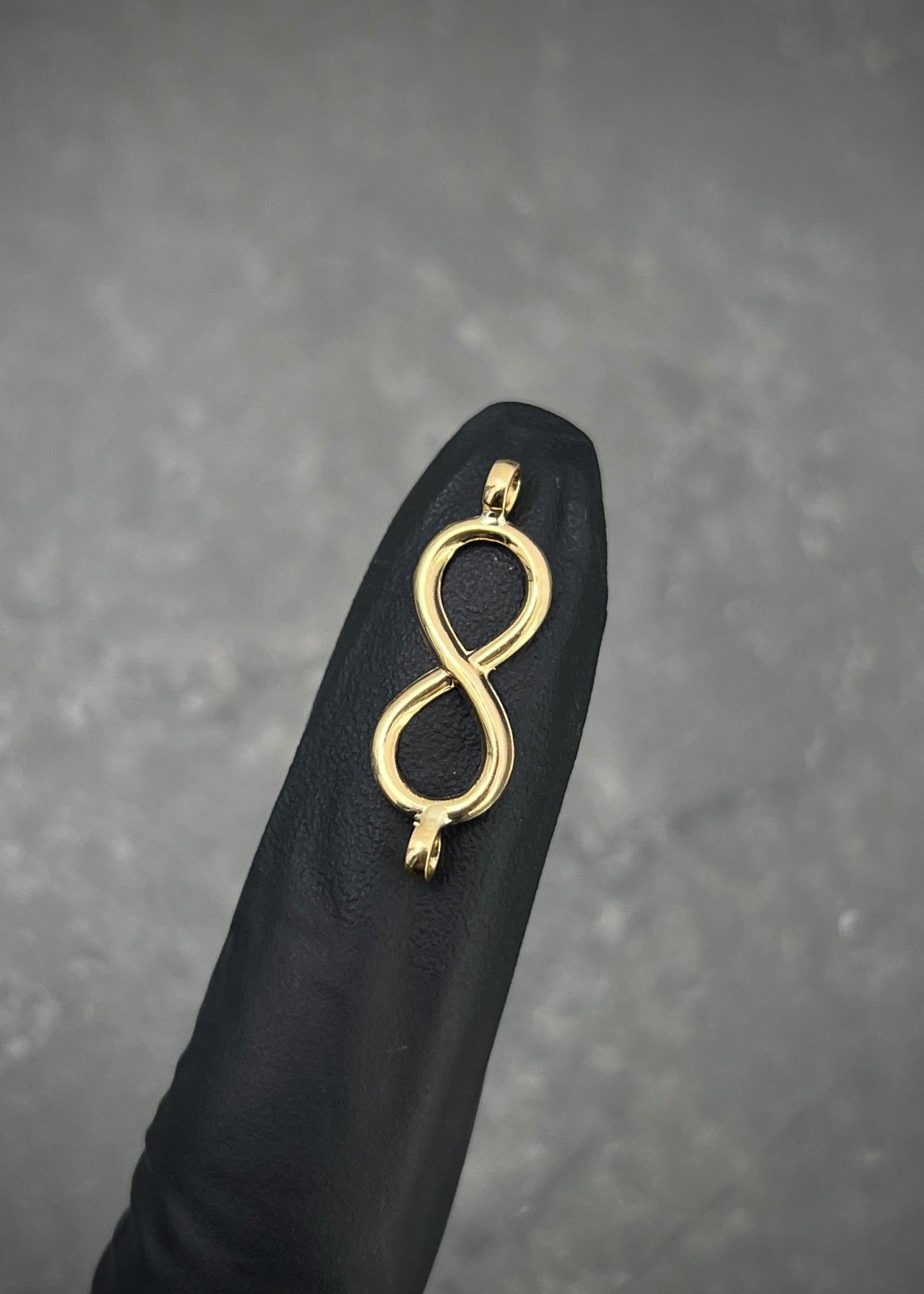 Herraje infinito 0.35gr / Largo 2.3cm / Oro Amarillo Nac B