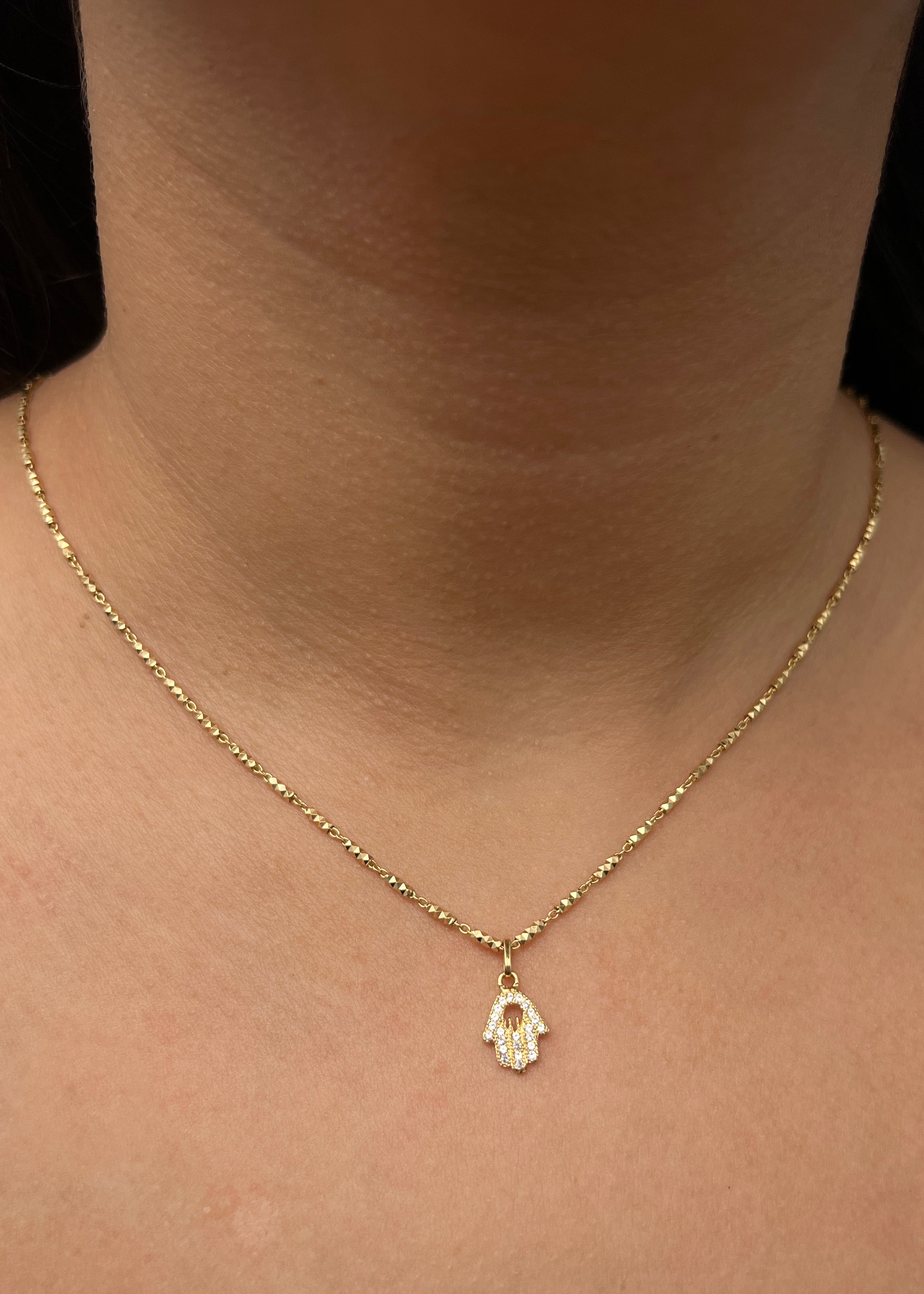 Dije mano hs con swarovski blanco 0.75gr / Largo 1.6cm / Oro Amarillo Nac M