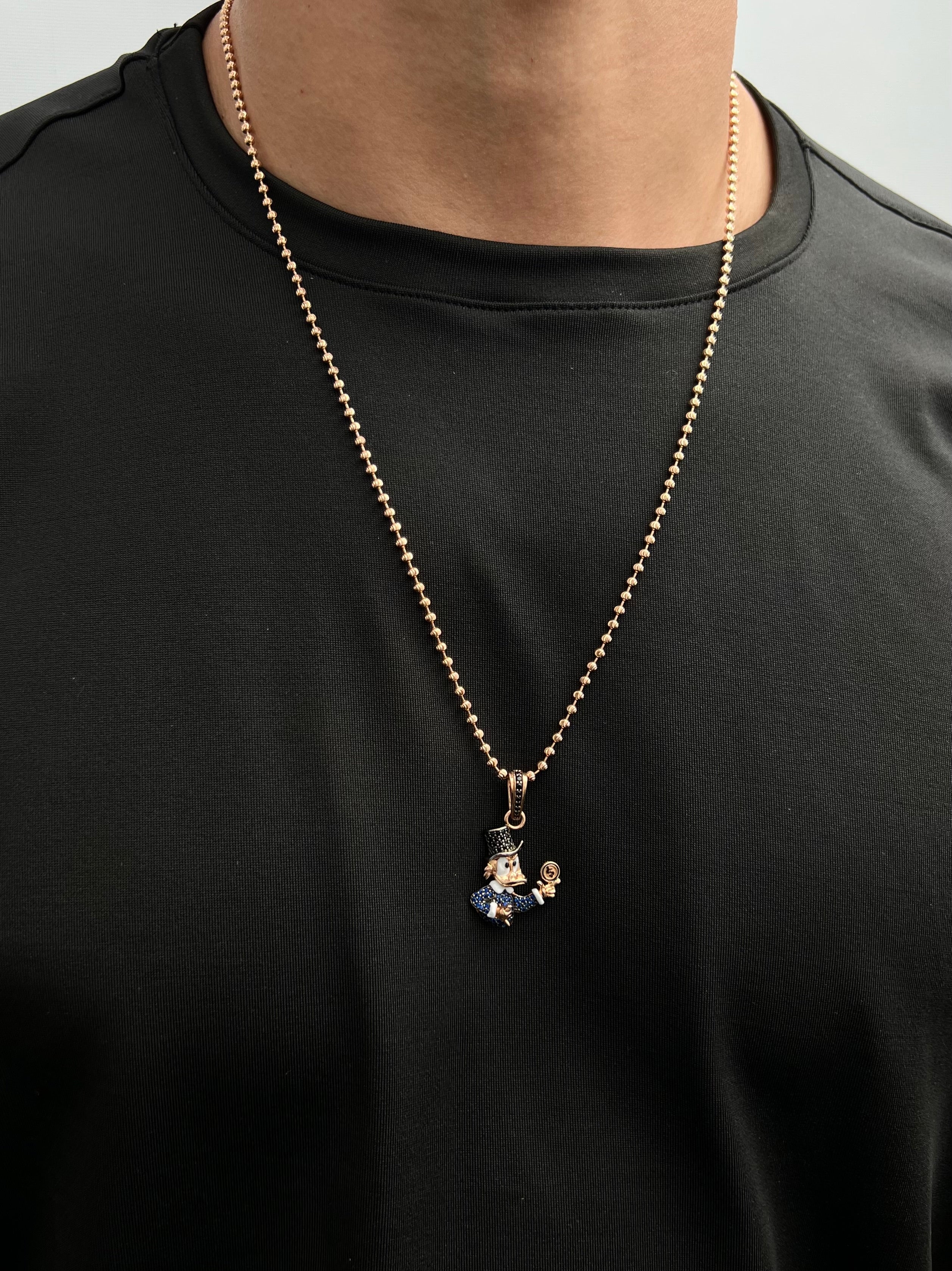 Dije tio rico con swarovski azul y negro 4.75gr / Largo 3.5cm / Oro Rosado Nac M