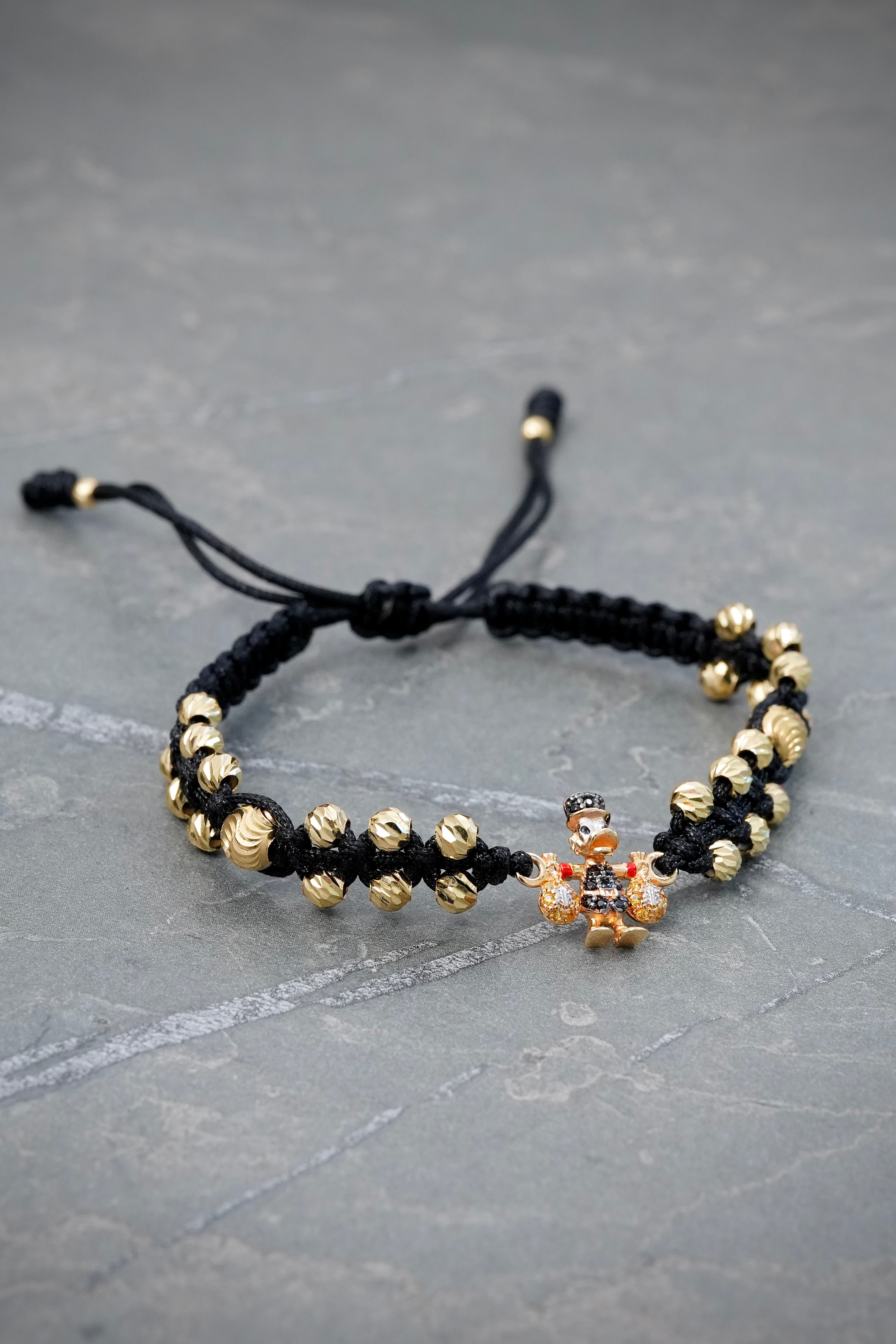 Pulsera en Hilo Negro con Herraje Tio Rico y Bolas Diamantadas 4.45gr — Oro Amarillo