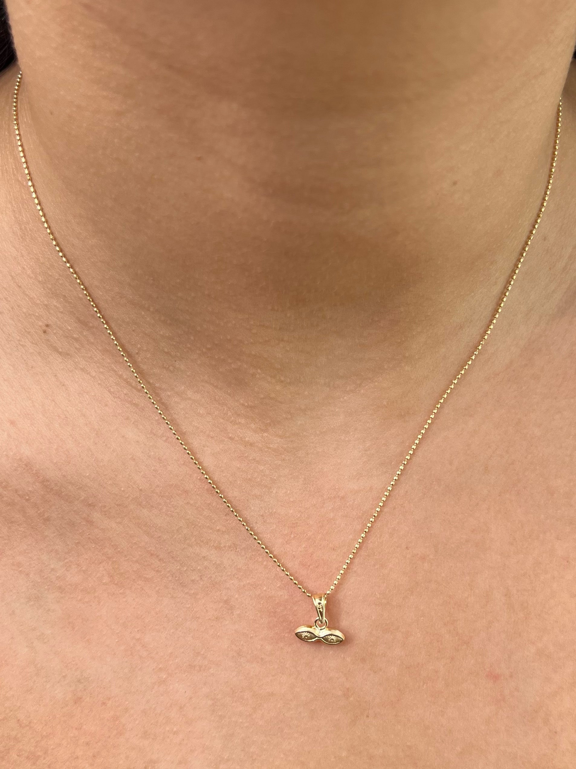 Dije ojos santa lucia 0.3gr / Largo 1.0cm / Oro Amarillo Nac P