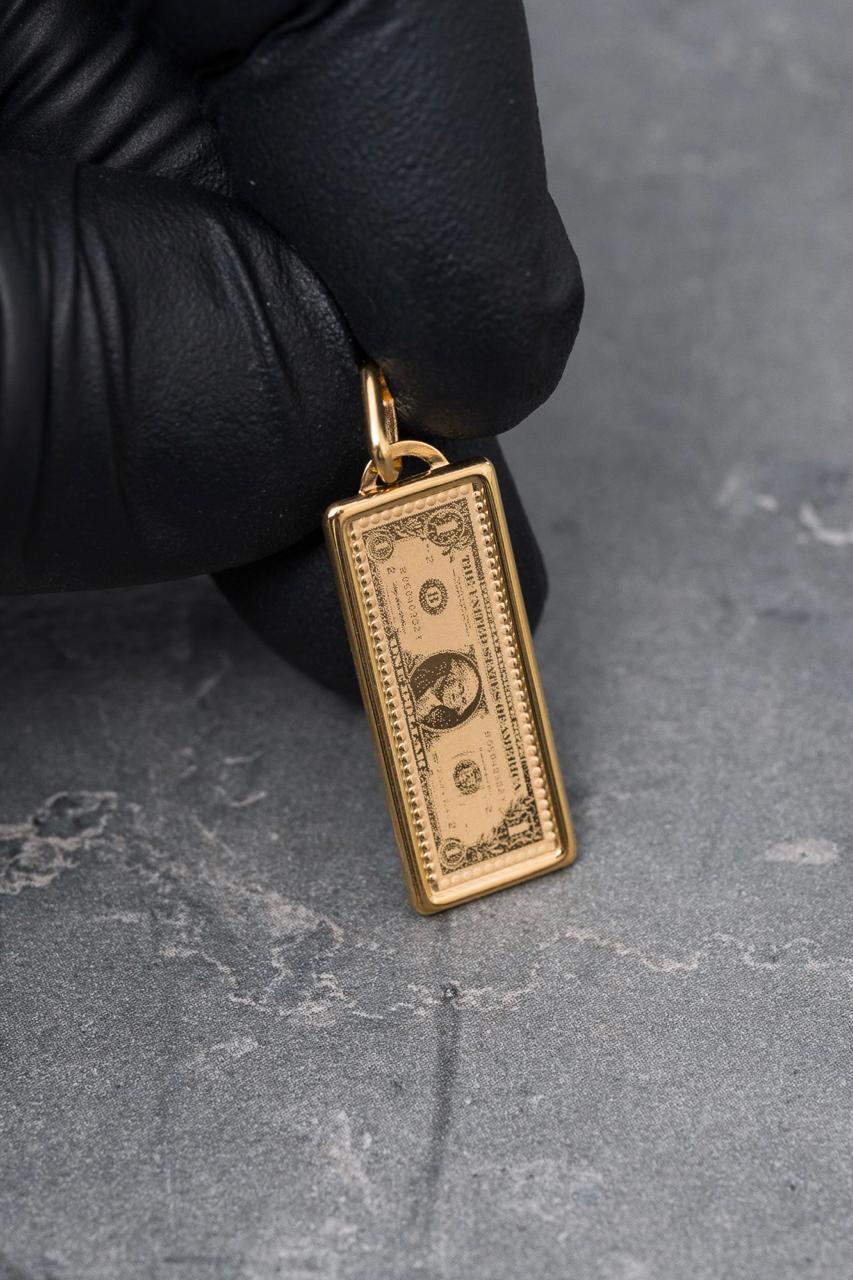 Dije dolar 1.1gr / Largo 3cm — Oro Amarillo