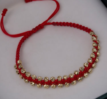 Pulsera en hilo rojo con bolas diamantadas 1.9gr / Oro Amarillo Nac (Joya) P