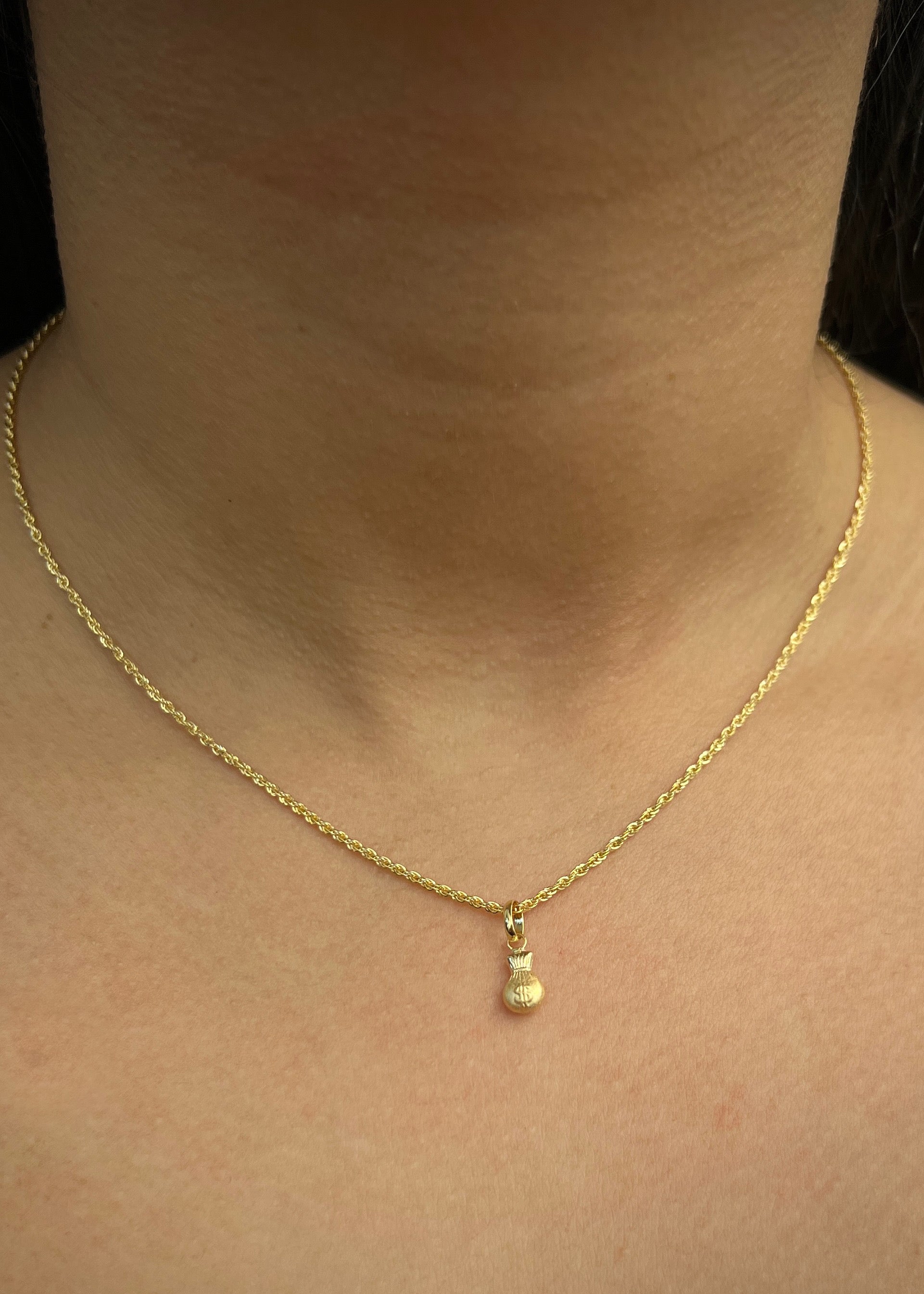 Dije bolsa de dinero 0.3gr / Largo 1.5cm / Oro Amarillo Nac *