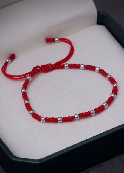 Pulsera en hilo rojo con bolas lisas 0.75gr / Oro Blanco (Joya) M