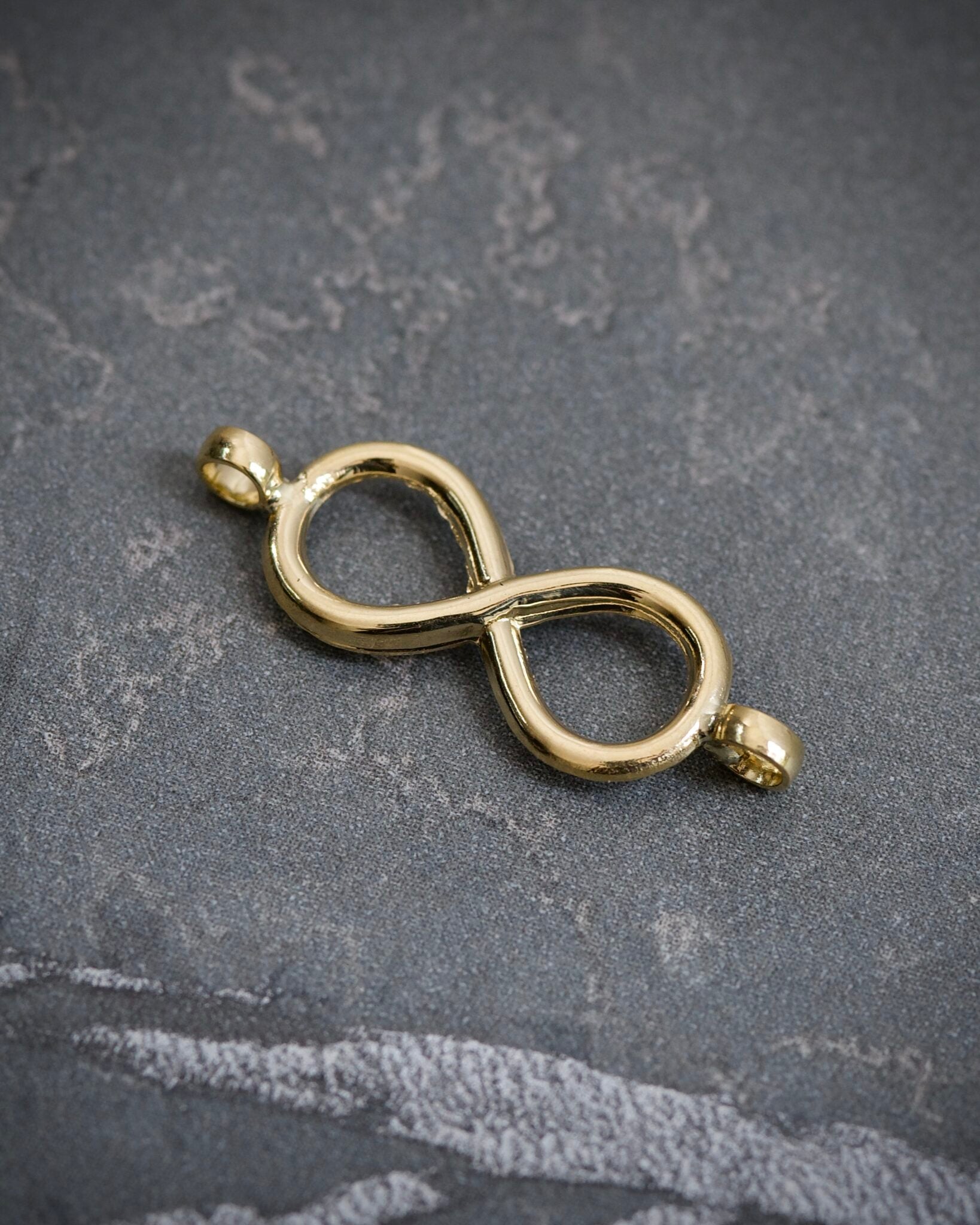 Herraje infinito 0.3gr / Largo 2,3cm / Oro Amarillo Nac B