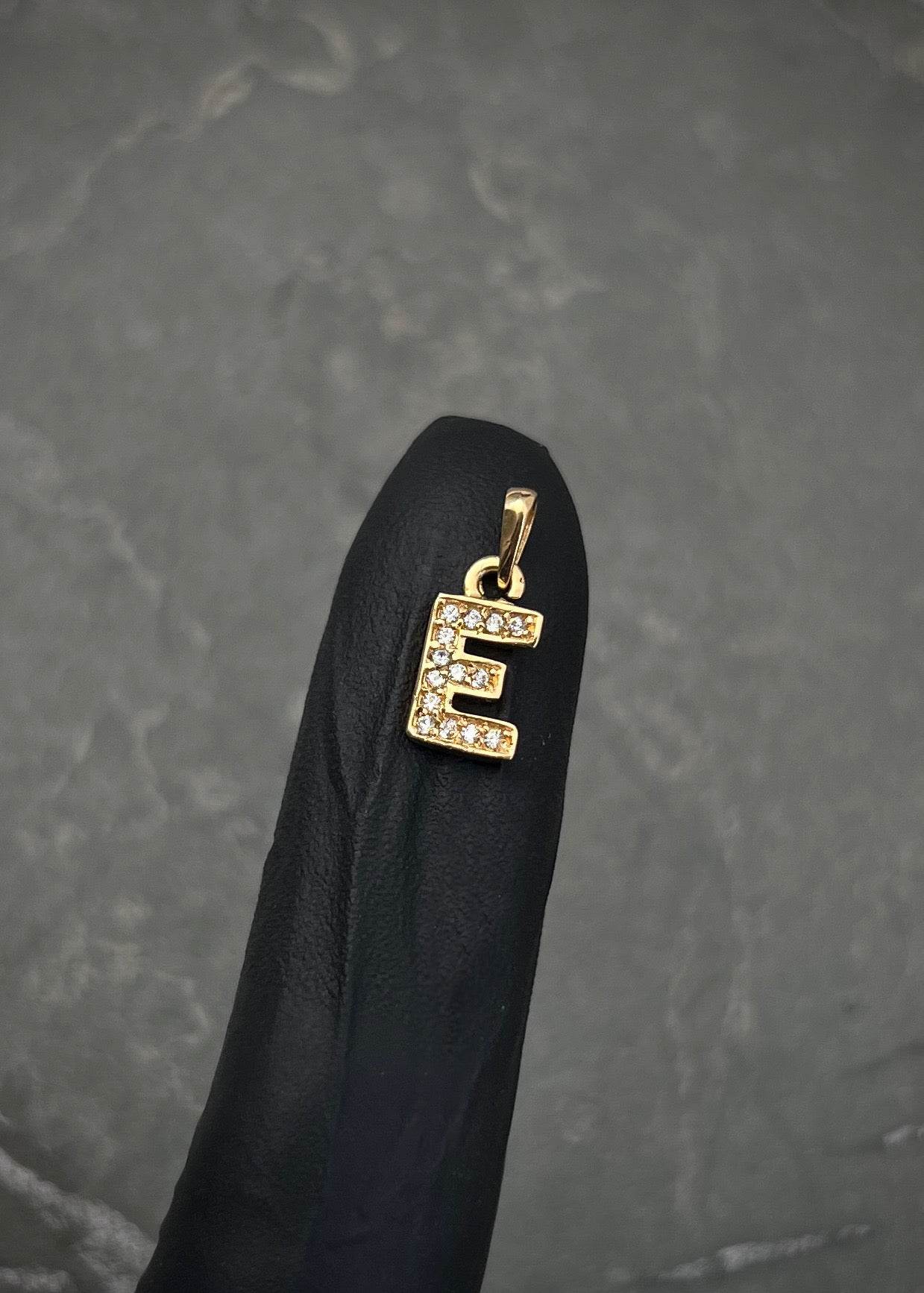 Dije letra e con swarovski blanco 0.85gr / Largo 1.4cm / Oro Amarillo Nac B