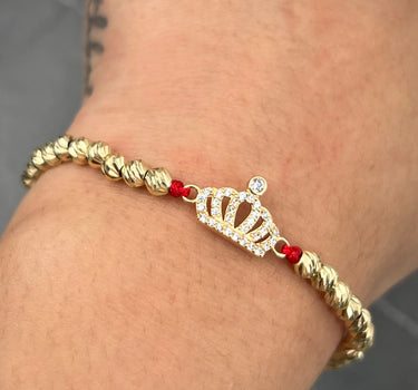 Pulsera en hilo rojo con herraje corona 3.05gr / Oro Amarillo (Joya) M