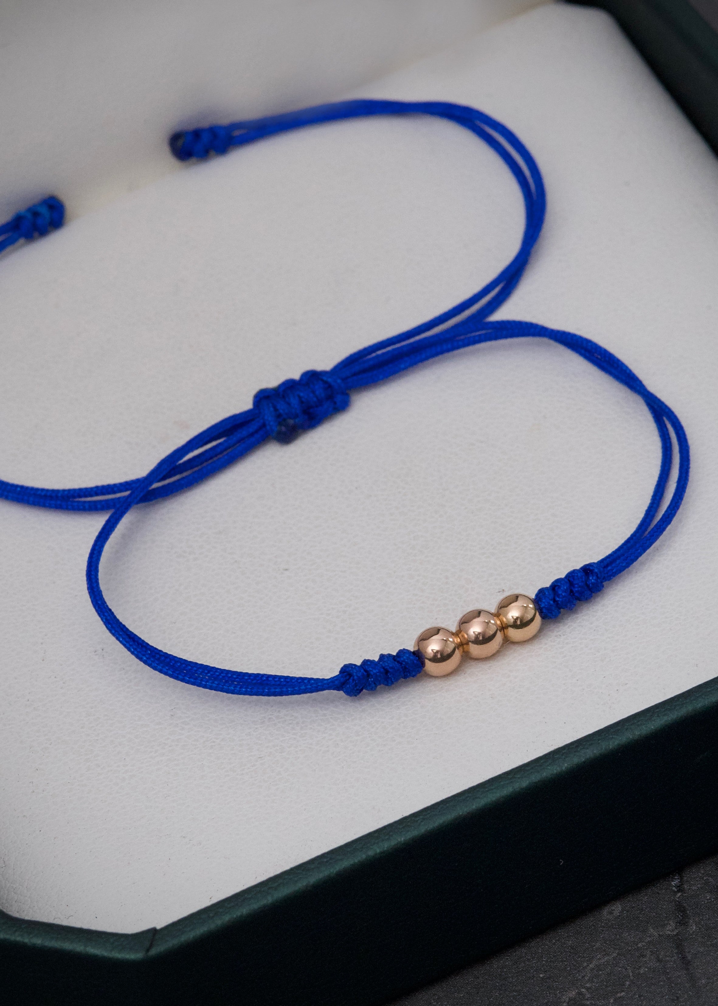 Pulsera en hilo azul con bolas lisas 4mm 0.25gr / Oro Rosado (Joya)*