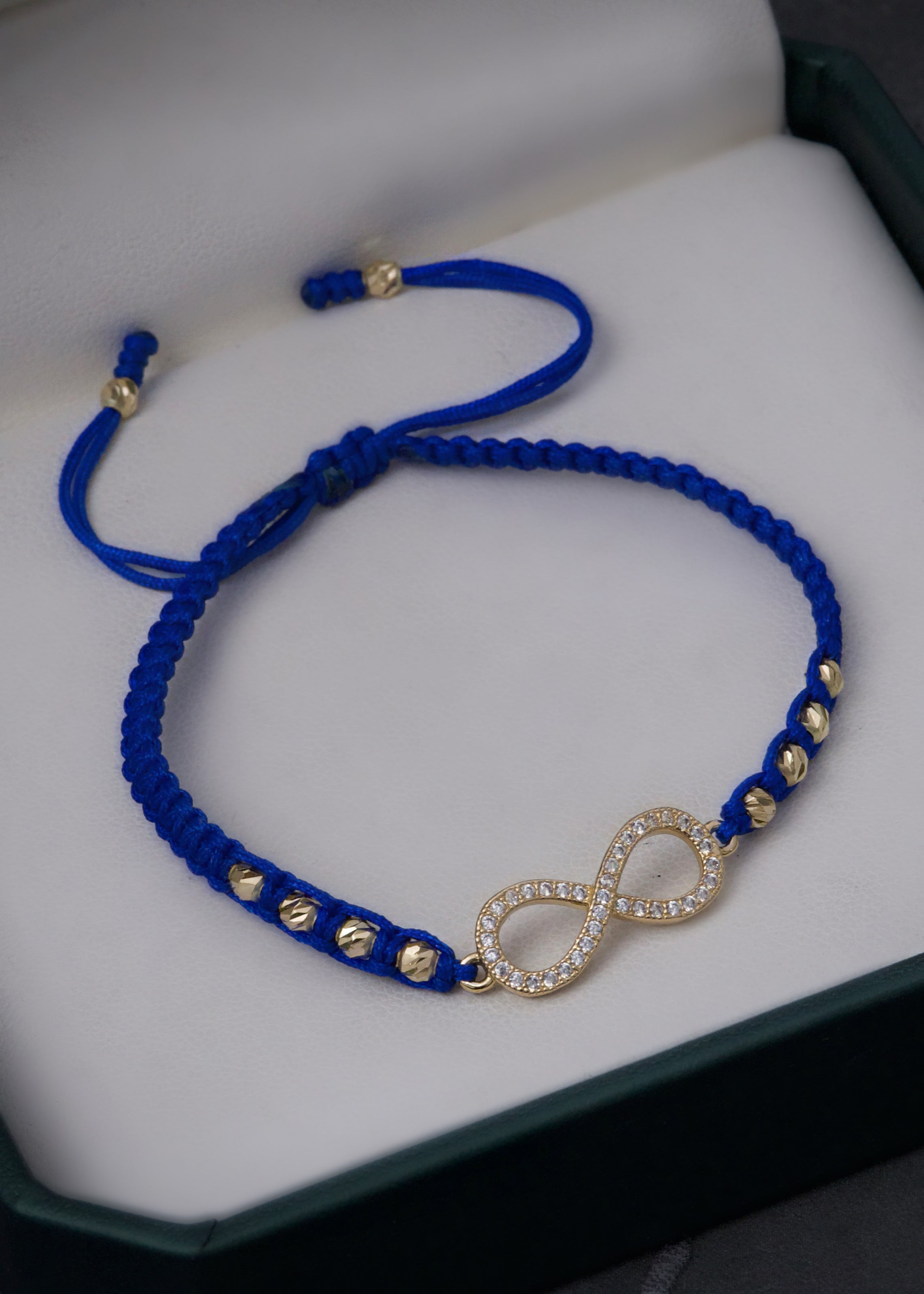 Pulsera en hilo azul con herraje infinito 1.75gr / Oro Amarillo (Joya)*