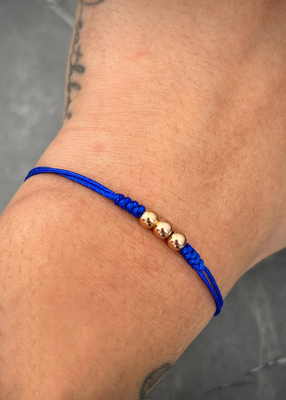 Pulsera en hilo azul con bolas lisas 4mm 0.25gr / Oro Rosado (Joya)*