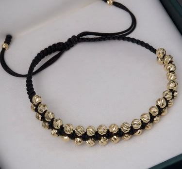 Pulsera en hilo negro con bolas diamantadas 3.7gr / Oro Amarillo Nac (Joya) P