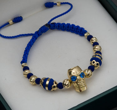 Pulsera de hilo azul con herraje de calavera y bolas diamatadas 10.8gr / Oro Amarillo (Joya) M