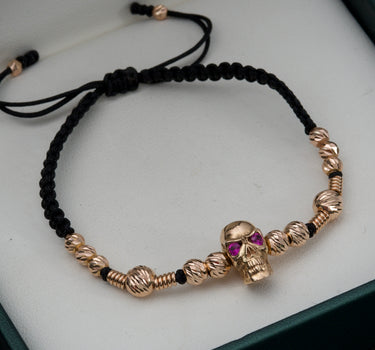 Pulsera de hilo negro con herraje de calavera y bolas diamantadas con herrajes de tubo 6.85gr / Oro Rosado (Joya) M