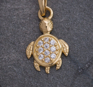 Dije tortuga con swarovski blanco 0.6gr / largo 1.5cm / Oro Amarillo Nac*
