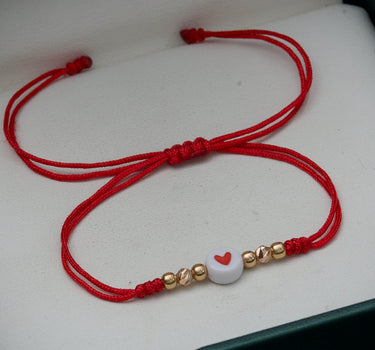 Pulsera en hilo rojo con corazon mas bolas lisas y diamantadas 0.3gr / Oro Rosado (Joya) M