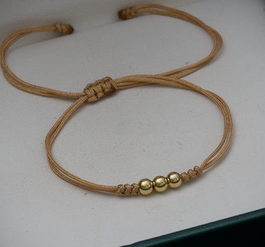 Pulsera en hilo beige con bolas lisas 4mm 0.3gr / Oro Amarillo (Joya) M