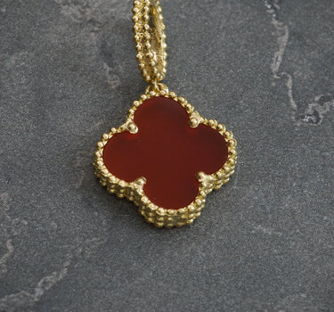 Dije lucky clover piedra roja 1.95gr / Largo 2.5 cm / Oro Amarillo Nac P