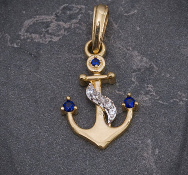 Dije ancla con swarovski azul y blanco 1.2gr / Largo 2.3cm / Oro Amarillo Nac M