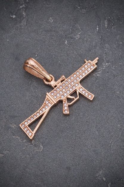 Dije de ametralladora con swarovski blanco 2.6gr / Largo 2cm / Oro Rosado Nac M