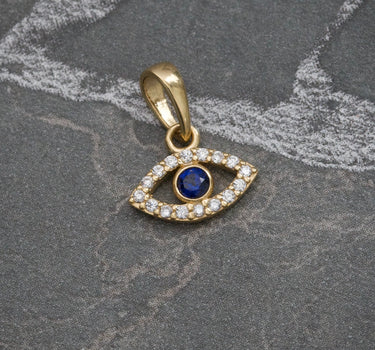Dije ojo turco piedra central azul oscura 0.6gr / 1.3cm / Oro Amarillo Nac B