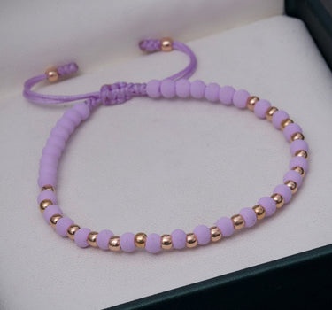 Pulsera en hilo Lila con bolas lisas 0.95gr / Oro Rosado (Joya) M