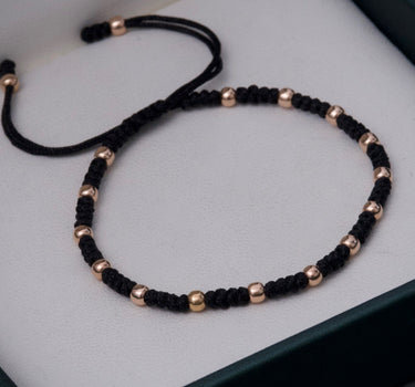 Pulsera en hilo negro con bolas lisas 0.75gr / Oro Rosado (Joya) M