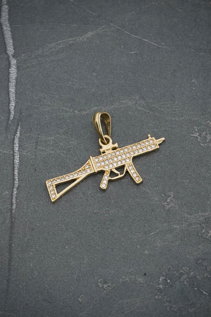 Dije ametralladora con swarovski blanco 2.7gr / Largo 2cm / Oro Amarillo Nac P