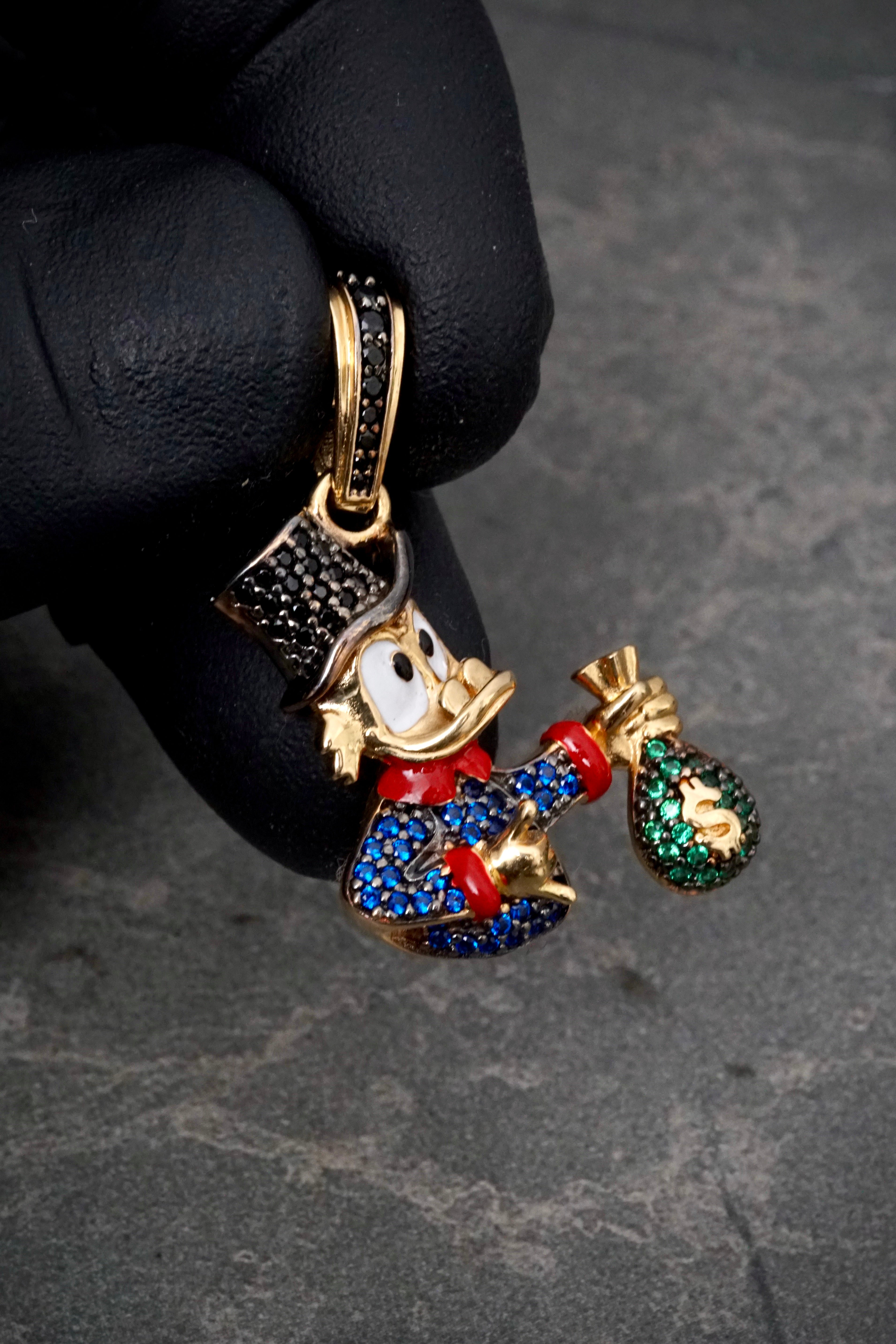 Dije tio rico con swarovski azul y negro 5.6gr / Largo 3.5cm / Oro Amarillo Nac P