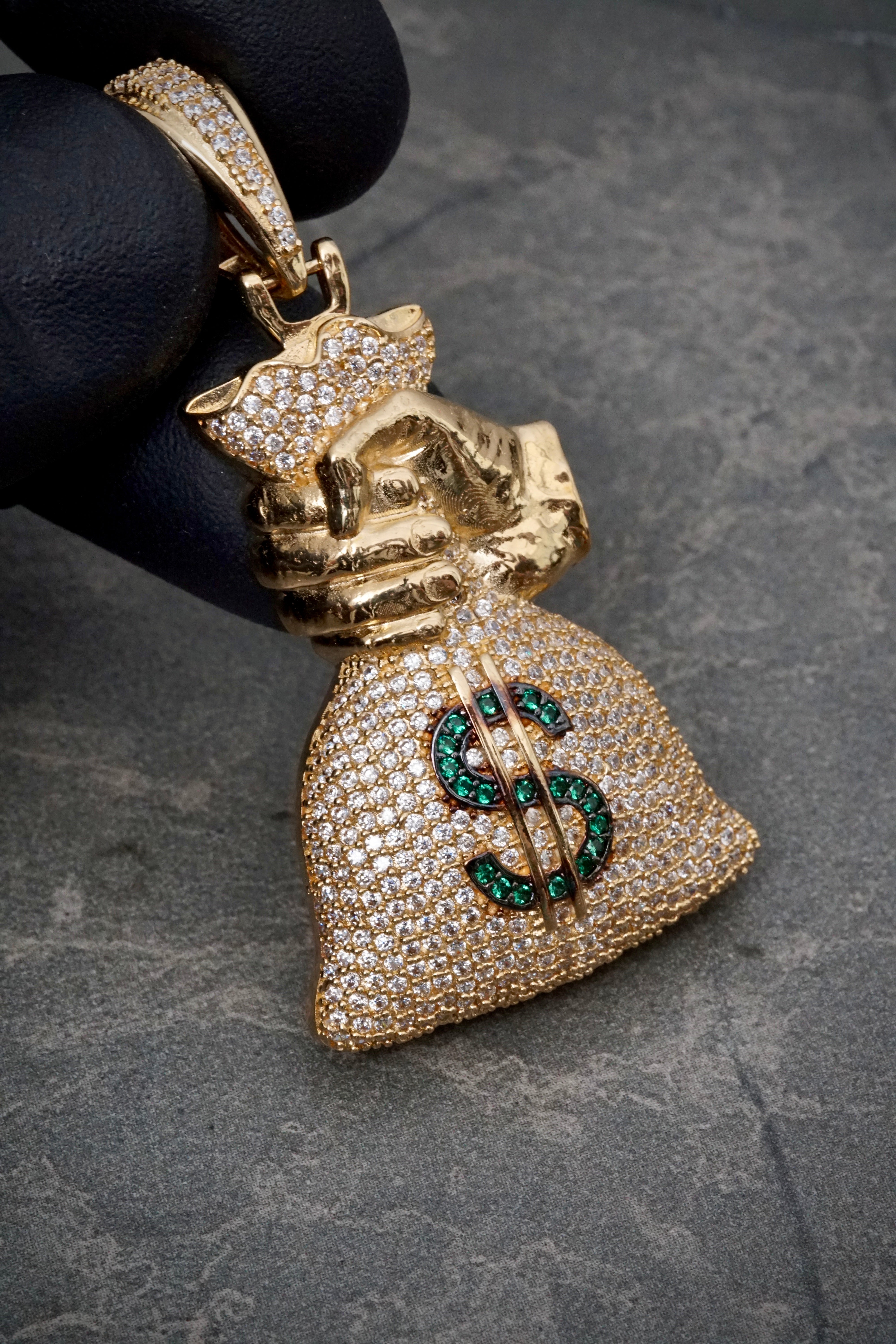 Dije bolsa de dinero con swarovski verde y blanco 11.9gr / Largo 5.3cm / Oro Amarillo Nac B