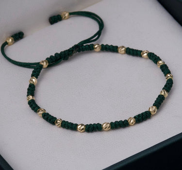Pulsera en hilo verde con bolas diamantadas 0.85gr / Oro Amarillo (Joya) M