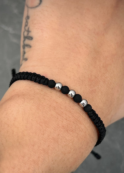 Pulsera en hilo negro con bolas lisas 4mm y neoprenos 0.25gr / Oro Blanco (Joya) M