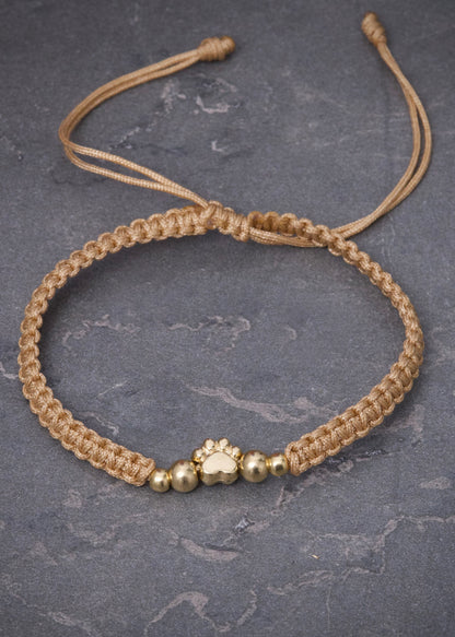 Pulsera en Hilo Beige con Herraje Huella 0.5gr — Oro Amarillo