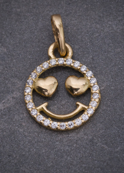 Dije cara feliz con swarovski blanco 0.8gr / Largo 1.8cm / Oro Amarillo Nac B