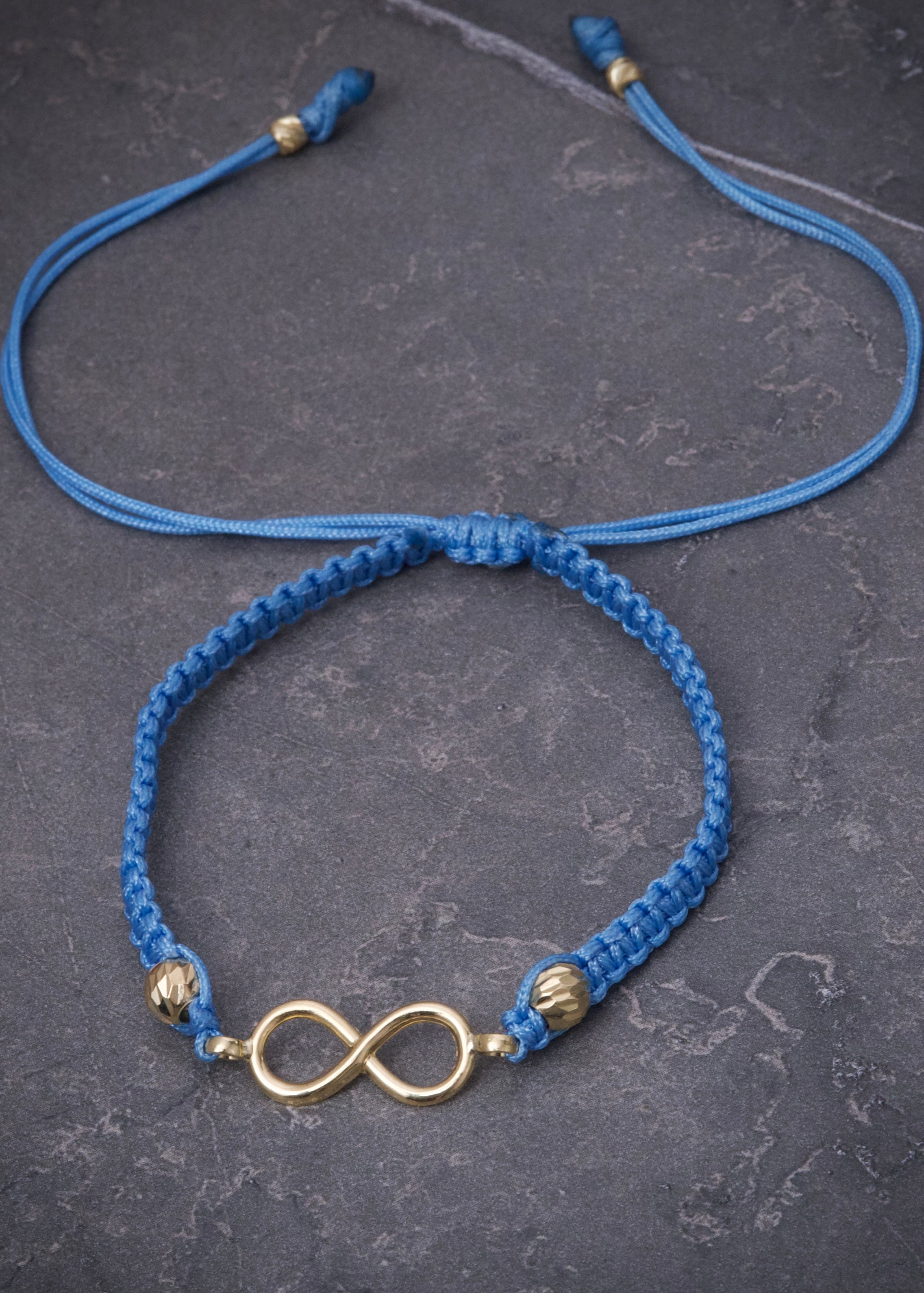 Pulsera en hilo azul con herraje infinito 0.8gr / Oro Amarillo (Joya) M