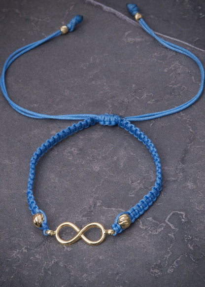 Pulsera en hilo azul con herraje infinito 0.8gr — Oro Amarillo