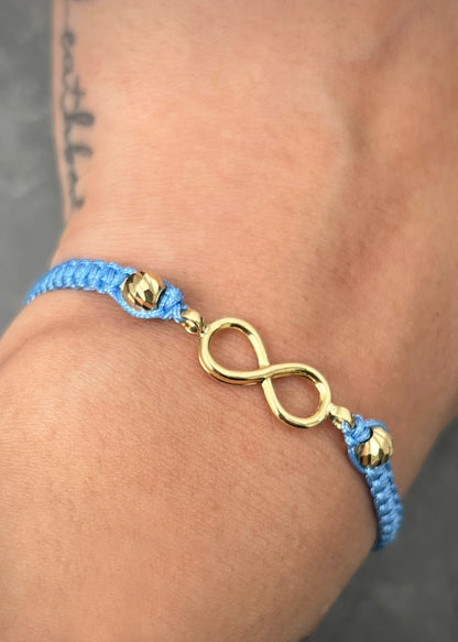 Pulsera en hilo azul con herraje infinito 0.8gr — Oro Amarillo