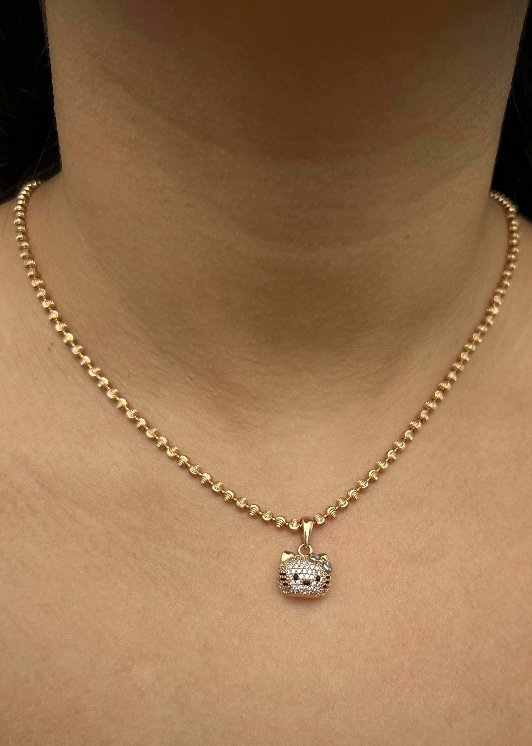 Dije hello kitty con swarovski blanco 2.8gr / Largo 1.7cm / Oro Rosado Nac M