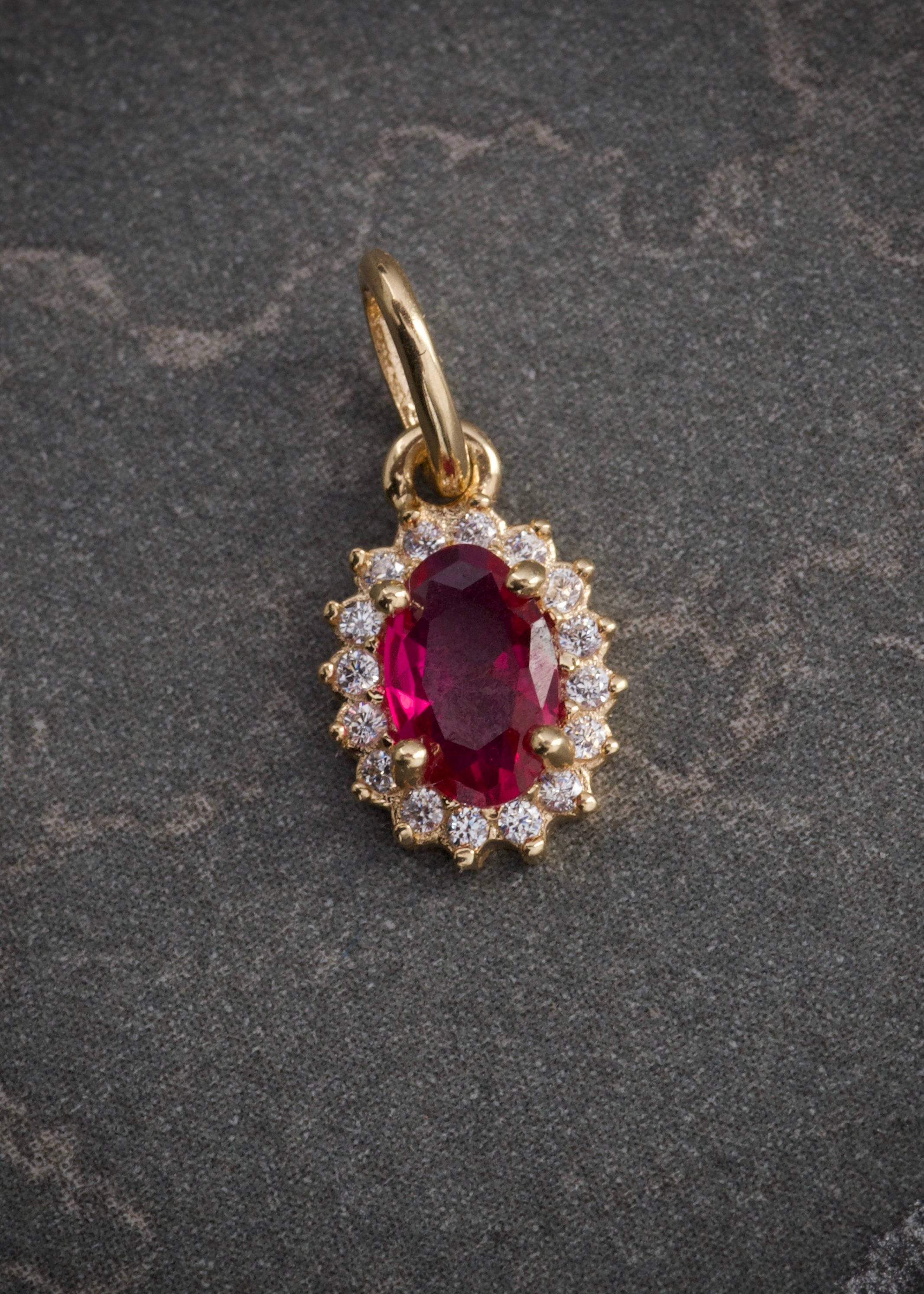 Dije ovalado con swarovski fucsia y blanco 0.6gr / Largo 1.4cm / Oro Amarillo Nac M