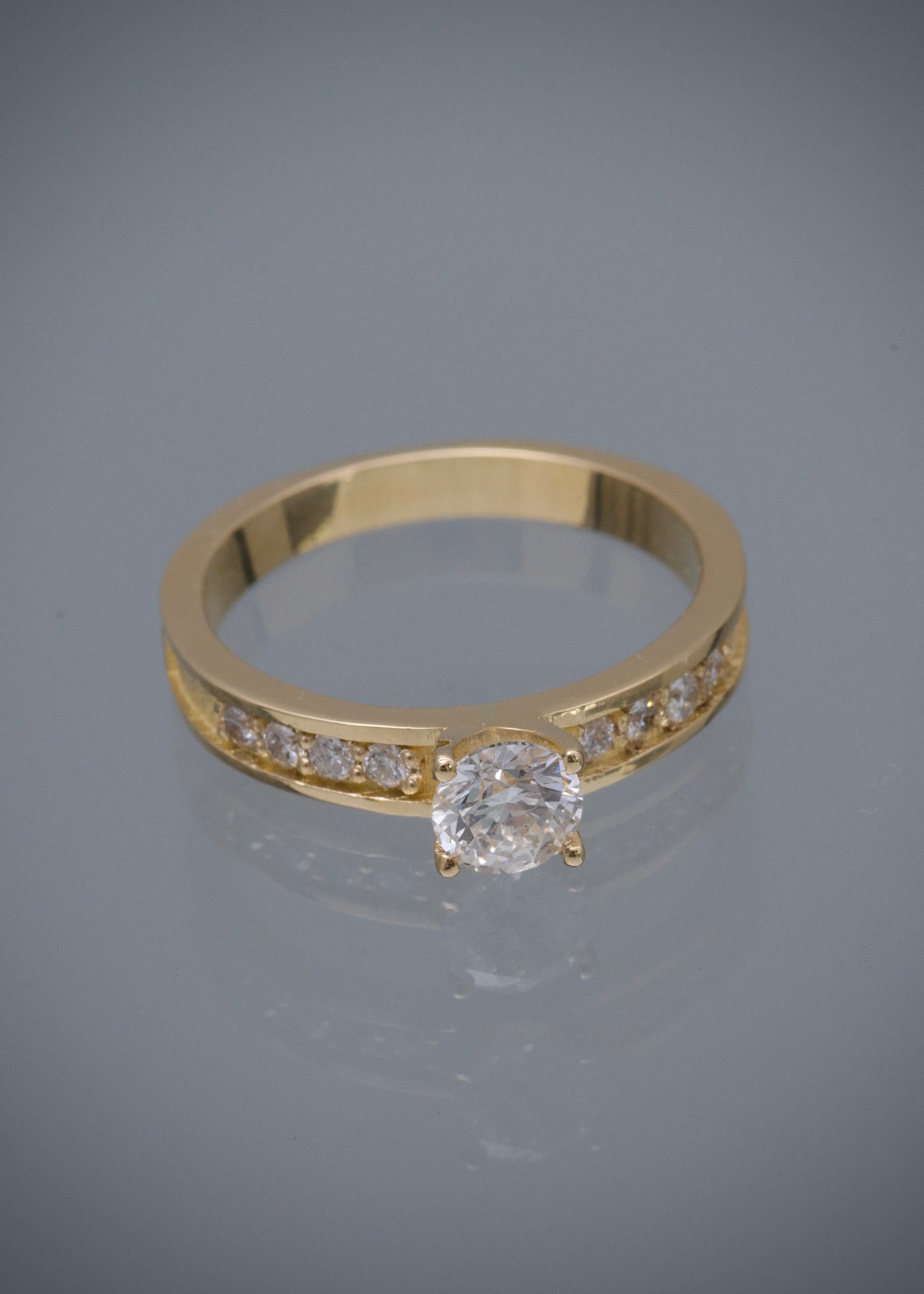 Solitario con 50pts de diamante central y 16pts de diamantes laterales 3.85gr / TALLA 6 1/2 / Oro Amarillo (Joya) M
