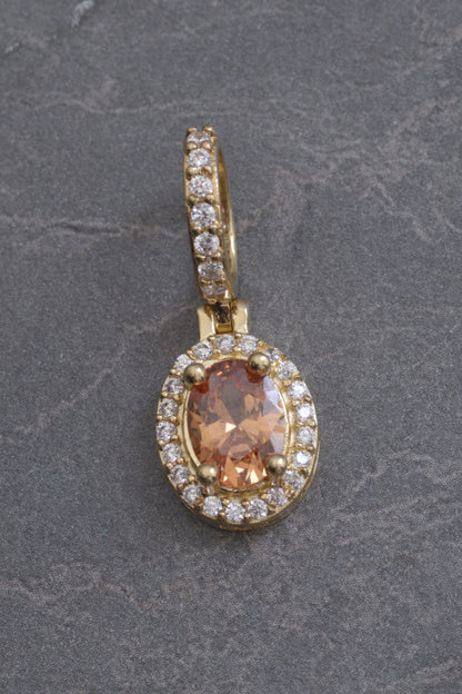 Dije ovalado con swarovski naranja y blanco 2.8gr / Largo 2.4cm / Oro Amarillo Nac M