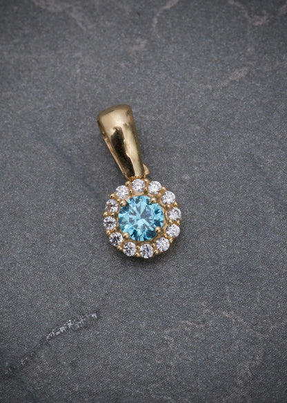 Dije flor con swarovski azul y blanco 0.9gr / Largo 1.3cm / Oro Amarillo Nac M