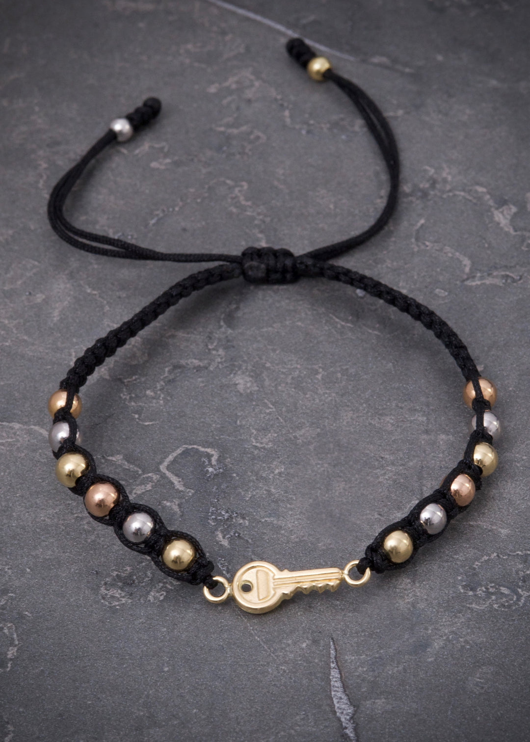 Pulsera en hilo negro con herraje llave 1.55gr — Tres Oros
