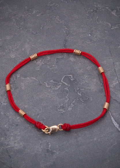 Pulsera en hilo rojo con herrajes de resorte 1.6gr / Oro Rosado (Joya) M
