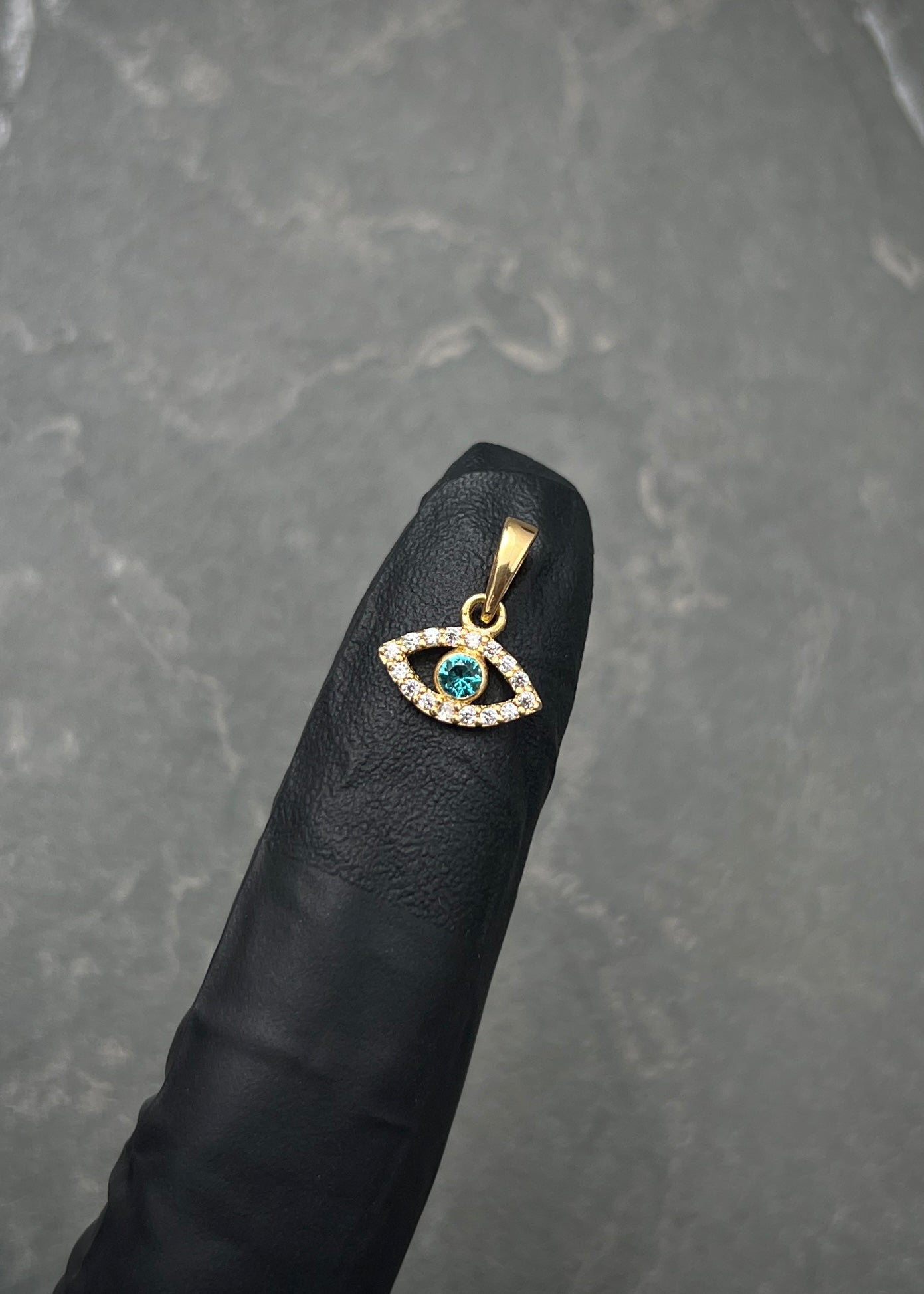 Dije ojo turco con swarovski blanco y azul 0.5gr / Largo 1.2cm / Oro Amarillo Nac P