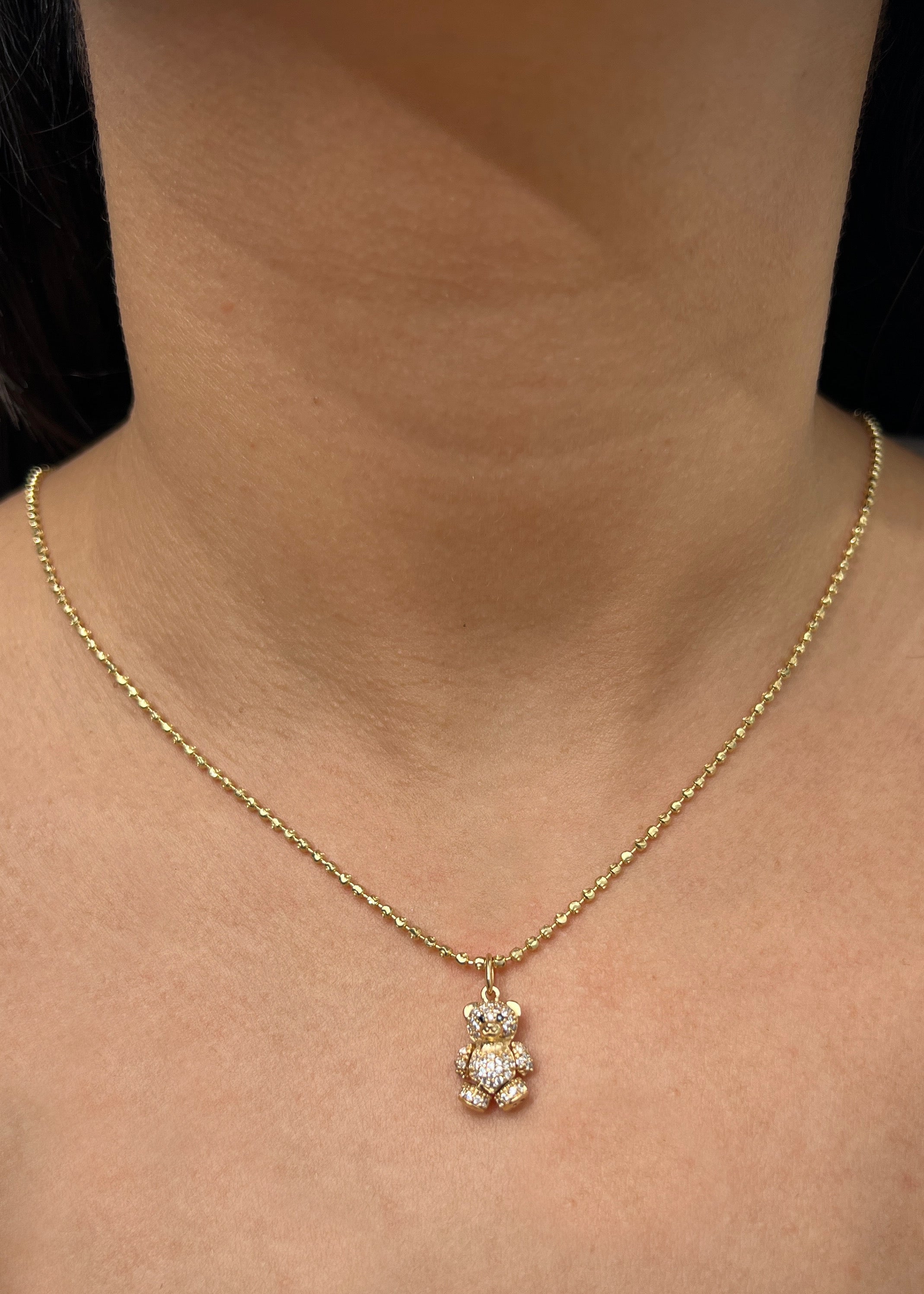 Dije oso articulado con swarovski blanco 2.6gr / Largo 2cm / Oro Amarillo Nac M