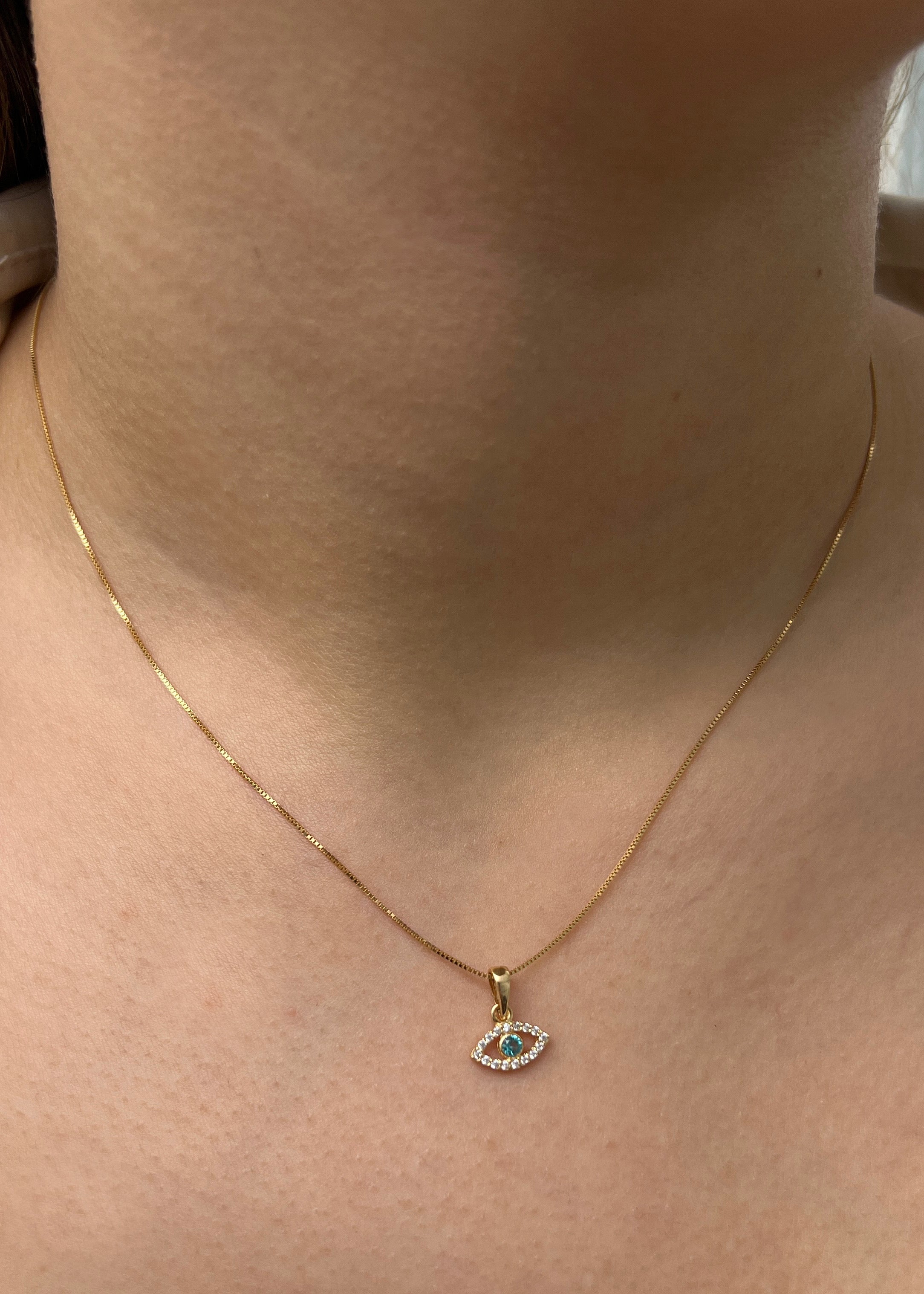 Dije ojo turco con swarovski blanco y azul 0.5gr / Largo 1.2cm / Oro Amarillo Nac P